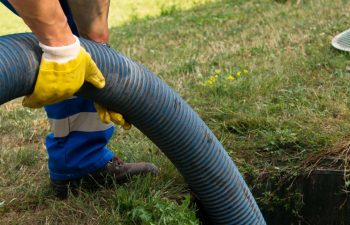 A Metro Septic technician performing septic tank pumping.