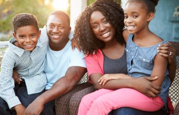 Happy Afro-American family of four.