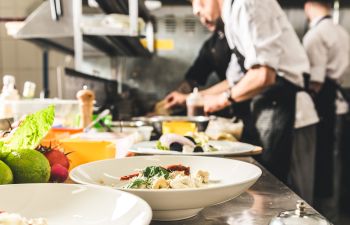 Professional chef working with his team in a restaurant kitchen.